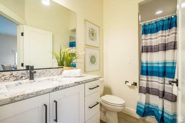 bathroom featuring toilet and vanity