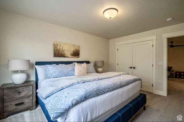 bedroom featuring a closet and light carpet