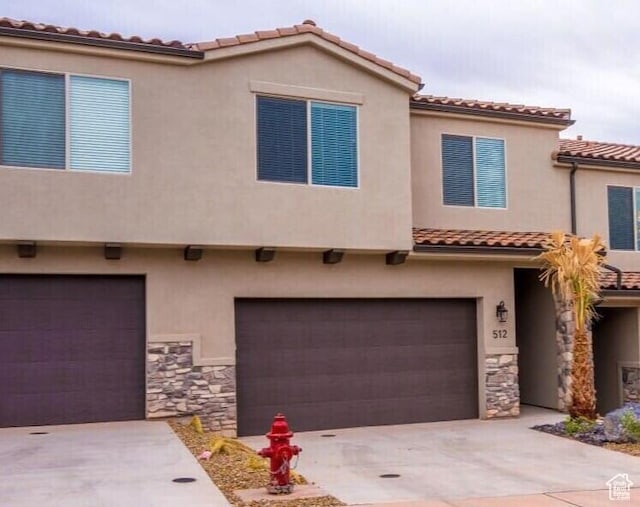 mediterranean / spanish home featuring a garage