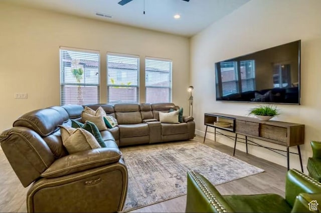 living room with ceiling fan and hardwood / wood-style flooring