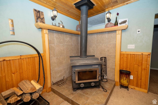 interior details featuring wooden walls and a wood stove