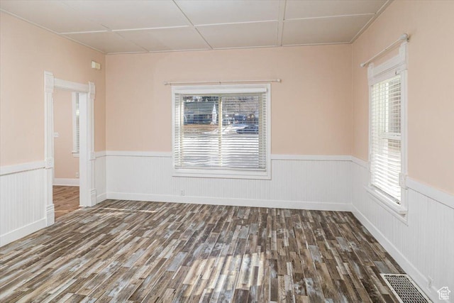 119 N 200 E, Smithfield, UT 84335 - empty room with wood finished floors, a wainscoted wall, and healthy amount of natural light