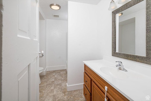 119 N 200 E, Smithfield, UT 84335 - full bath with toilet, vanity, baseboards, and stone finish floors