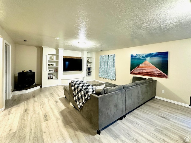 1094 W 400 S, Layton, UT 84041 - living area with wood finished floors, a textured ceiling, baseboards, and built in shelves