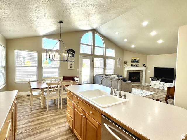 1094 W 400 S, Layton, UT 84041 - kitchen with a sink, lofted ceiling, light wood-style floors, light countertops, and brown cabinetry