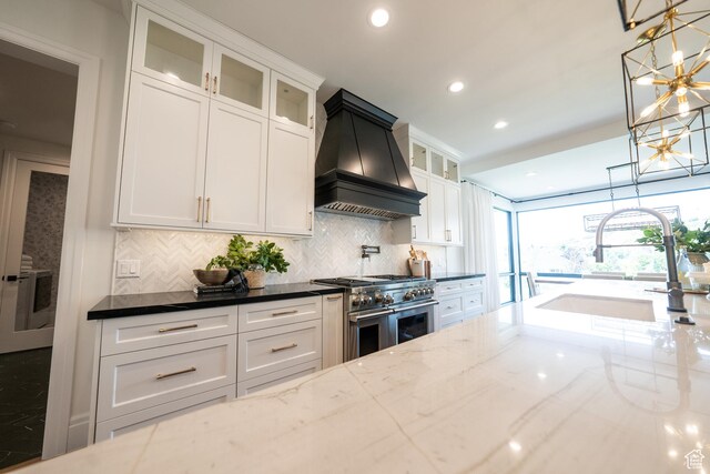 287 E Heritage Dr, Alpine, UT 84004 - kitchen featuring custom exhaust hood, double oven range, a chandelier, dark stone countertops, and backsplash