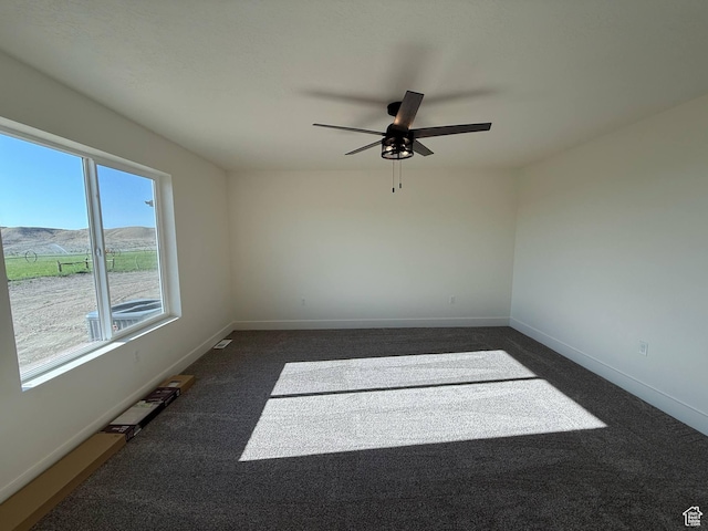 1030 N 200 E, Ferron, UT 84523 - unfurnished room featuring a ceiling fan, dark colored carpet, and baseboards
