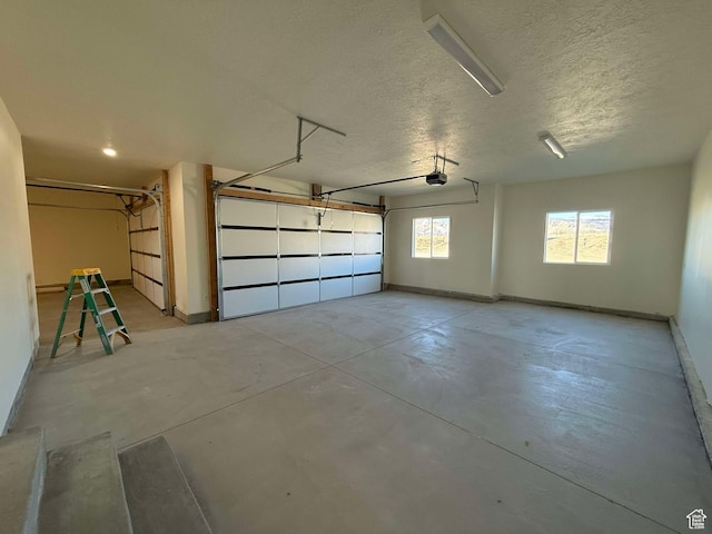 garage with baseboards and a garage door opener