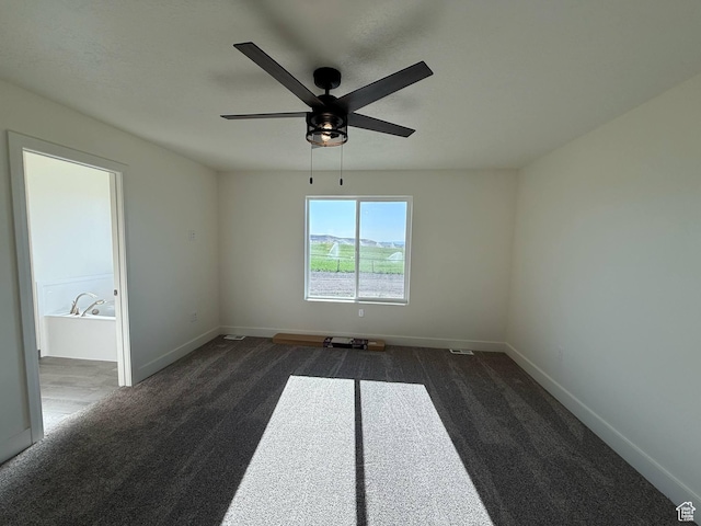 1030 N 200 E, Ferron, UT 84523 - empty room featuring dark carpet, a ceiling fan, and baseboards