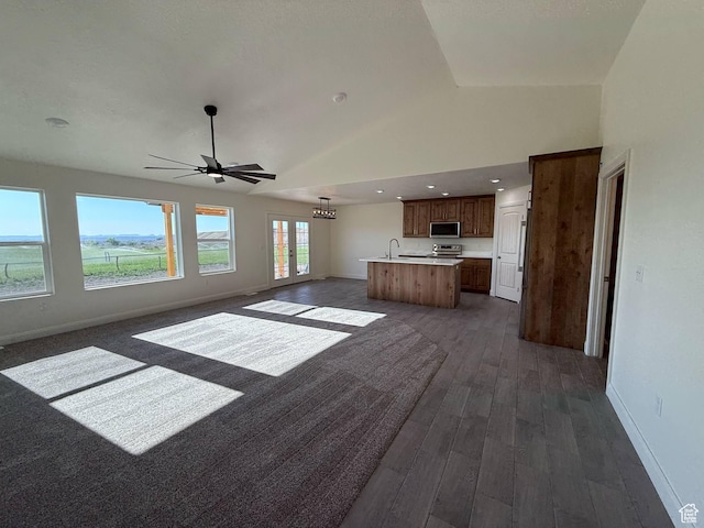 1030 N 200 E, Ferron, UT 84523 - unfurnished living room with dark wood finished floors, baseboards, ceiling fan, high vaulted ceiling, and a sink