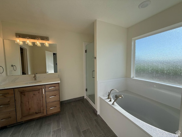 1030 N 200 E, Ferron, UT 84523 - full bath with vanity, a bath, a stall shower, wood finish floors, and baseboards
