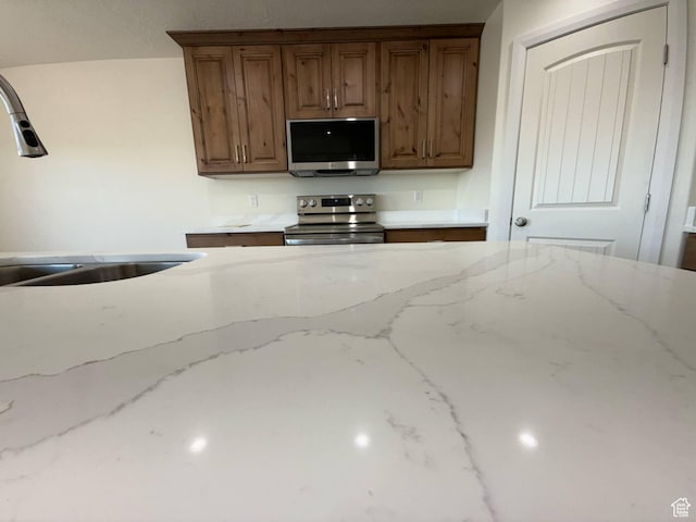 1030 N 200 E, Ferron, UT 84523 - kitchen featuring stainless steel appliances, a sink, and light stone countertops