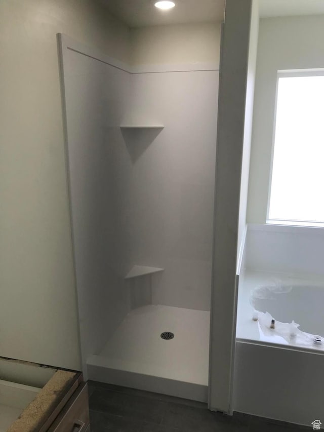 bathroom with a garden tub and a shower stall