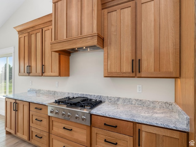 0, Preston, ID 83263 - kitchen featuring vaulted ceiling, stainless steel gas stovetop, light hardwood / wood-style floors, custom exhaust hood, and light stone counters