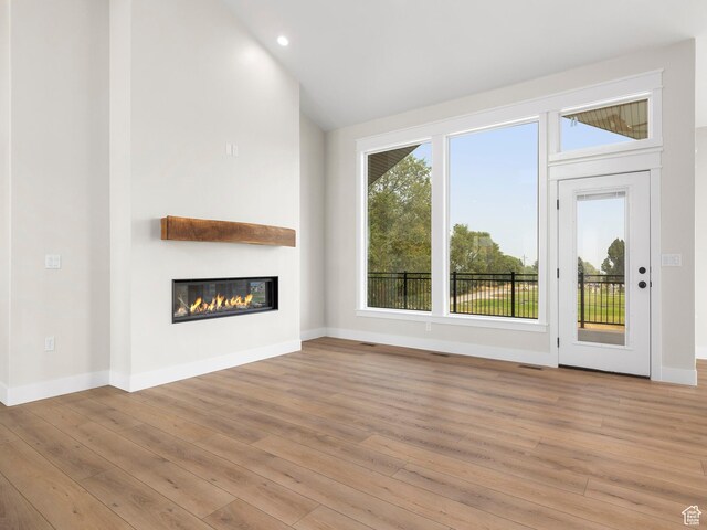 0, Preston, ID 83263 - unfurnished living room featuring light wood-type flooring and high vaulted ceiling