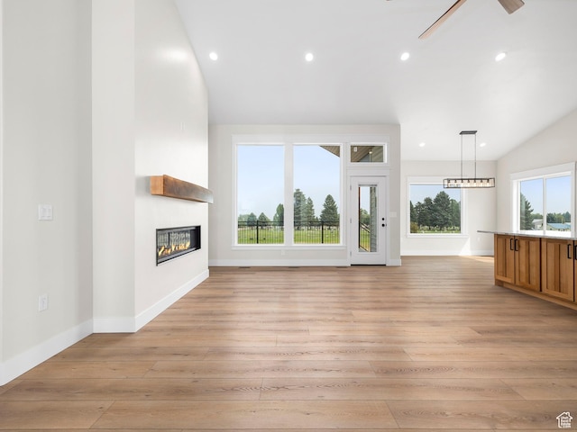 0, Preston, ID 83263 - unfurnished living room featuring lofted ceiling, light wood-type flooring, a fireplace, and ceiling fan