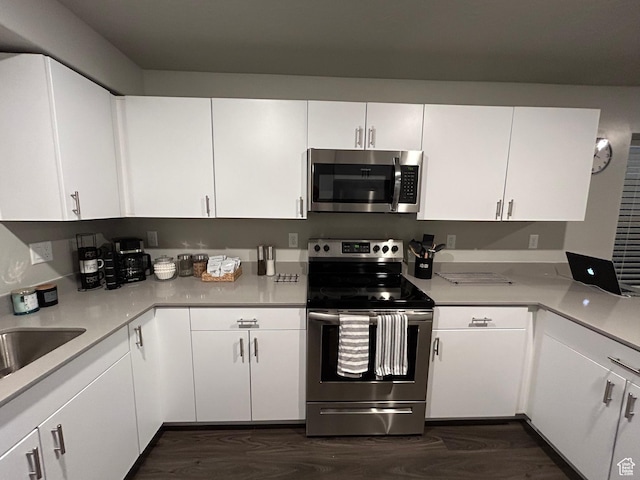 128 N Lone Rock Dr Unit A105, Hurricane, UT 84737 - kitchen featuring stainless steel appliances, dark wood finished floors, light countertops, and white cabinetry