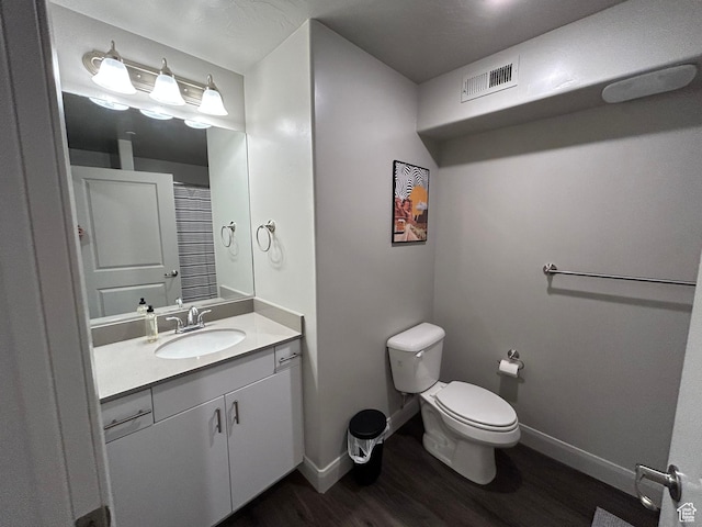 128 N Lone Rock Dr Unit A105, Hurricane, UT 84737 - bathroom with visible vents, toilet, wood finished floors, baseboards, and vanity