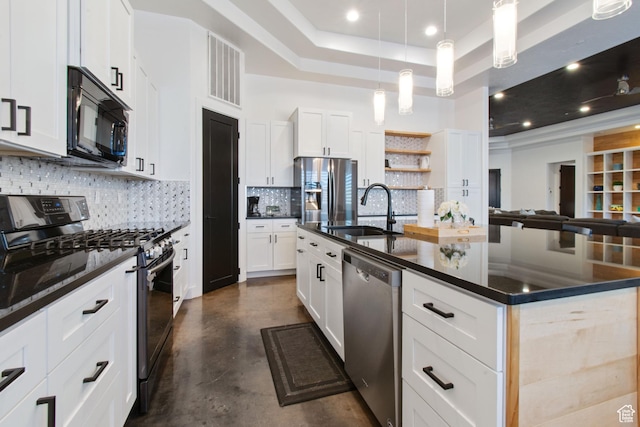 3243 S Hideaway Pl, Hurricane, UT 84737 - kitchen with white cabinets, appliances with stainless steel finishes, sink, a tray ceiling, and a center island with sink