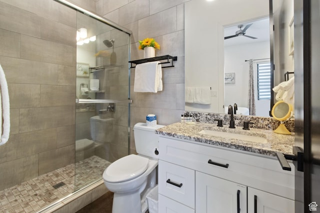 3243 S Hideaway Pl, Hurricane, UT 84737 - bathroom featuring toilet, ceiling fan, a shower with door, and vanity