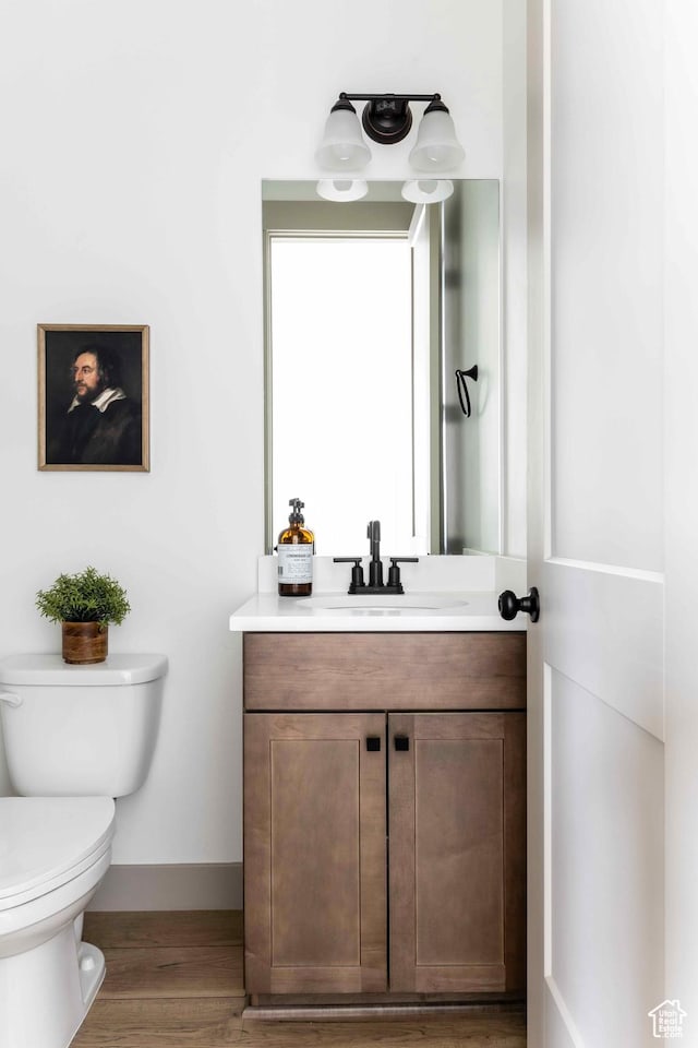 6968 Elk Wallow Dr, Park City, UT 84098 - bathroom featuring toilet, vanity, baseboards, and wood finished floors