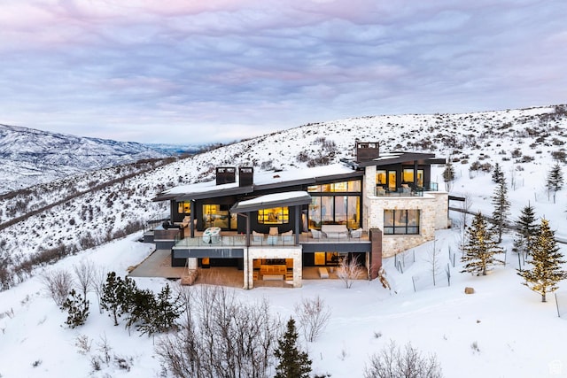 9491 N Promontory Summit Dr, Park City, UT 84098 - snow covered rear of property featuring a mountain view and a chimney