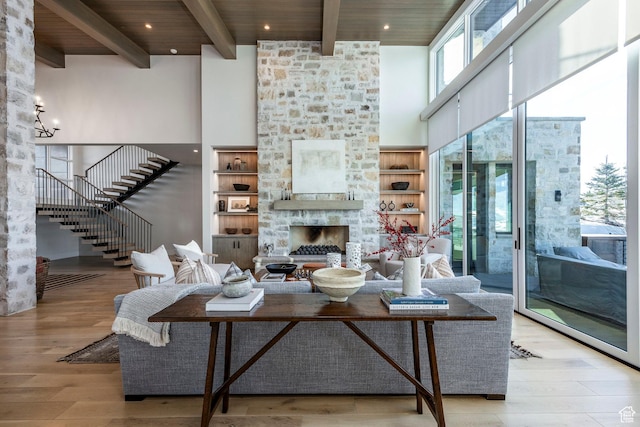 9491 N Promontory Summit Dr, Park City, UT 84098 - living room featuring a fireplace, a towering ceiling, and light wood finished floors