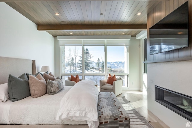 9491 N Promontory Summit Dr, Park City, UT 84098 - bedroom featuring wood ceiling, beam ceiling, a large fireplace, and wood finished floors