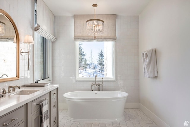 9491 N Promontory Summit Dr, Park City, UT 84098 - full bathroom with a notable chandelier, a soaking tub, tile patterned flooring, and tile walls