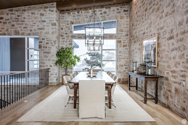 9491 N Promontory Summit Dr, Park City, UT 84098 - unfurnished dining area featuring a high ceiling, light wood finished floors, and an inviting chandelier