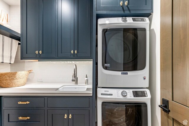 9491 N Promontory Summit Dr, Park City, UT 84098 - laundry room featuring stacked washer and clothes dryer, a sink, and cabinet space