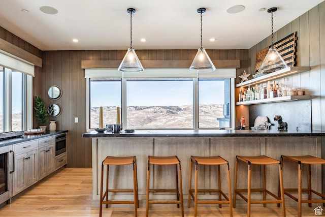 9491 N Promontory Summit Dr, Park City, UT 84098 - kitchen featuring a mountain view, a breakfast bar, open shelves, stainless steel microwave, and dark countertops