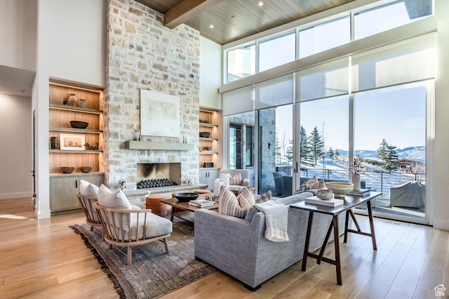 9491 N Promontory Summit Dr, Park City, UT 84098 - living area featuring wooden ceiling, a high ceiling, a fireplace, light wood-type flooring, and beam ceiling