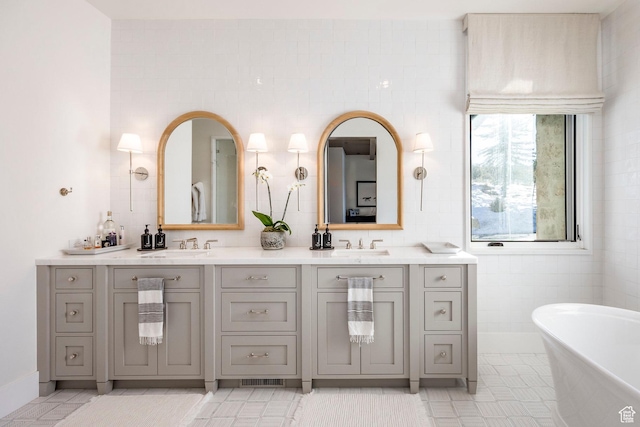 9491 N Promontory Summit Dr, Park City, UT 84098 - full bathroom featuring tile patterned flooring, a freestanding tub, a sink, and double vanity