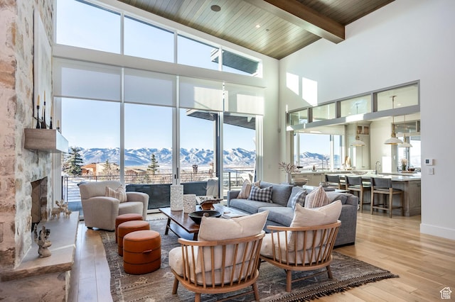 9491 N Promontory Summit Dr, Park City, UT 84098 - living area featuring light wood-style floors, a wealth of natural light, a mountain view, and beamed ceiling