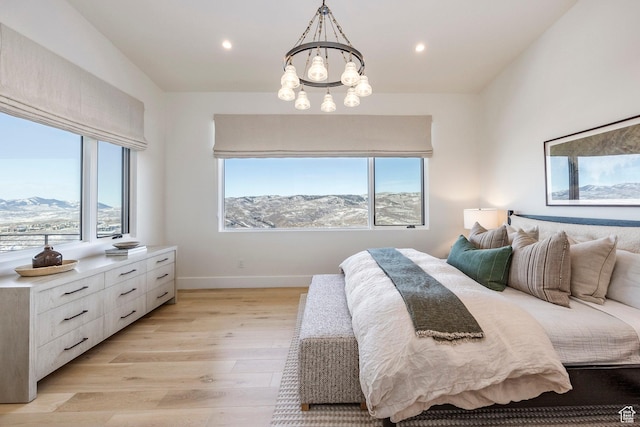 9491 N Promontory Summit Dr, Park City, UT 84098 - bedroom with light wood finished floors, multiple windows, a mountain view, and a notable chandelier