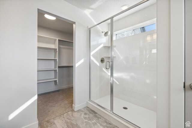 2344 N White Cliff Dr, Lehi, UT 84043 - full bathroom with a stall shower, a spacious closet, and baseboards