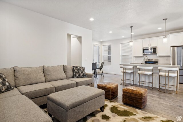 2344 N White Cliff Dr, Lehi, UT 84043 - living room featuring recessed lighting, baseboards, and light wood finished floors