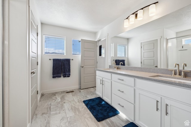 2344 N White Cliff Dr, Lehi, UT 84043 - bathroom with double vanity, a stall shower, a sink, and baseboards