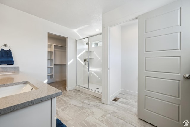 2344 N White Cliff Dr, Lehi, UT 84043 - full bath featuring visible vents, marble finish floor, double vanity, a stall shower, and a walk in closet