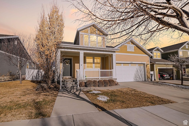 view of front of home with covered porch and a garage