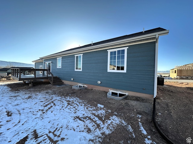 snow covered property featuring a deck