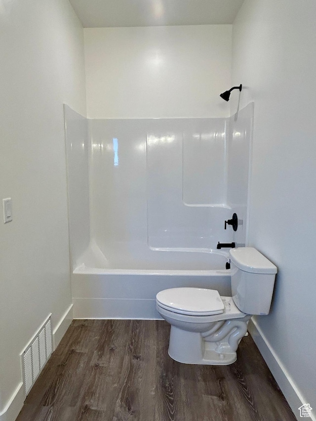 bathroom featuring toilet, shower / bathtub combination, and wood-type flooring