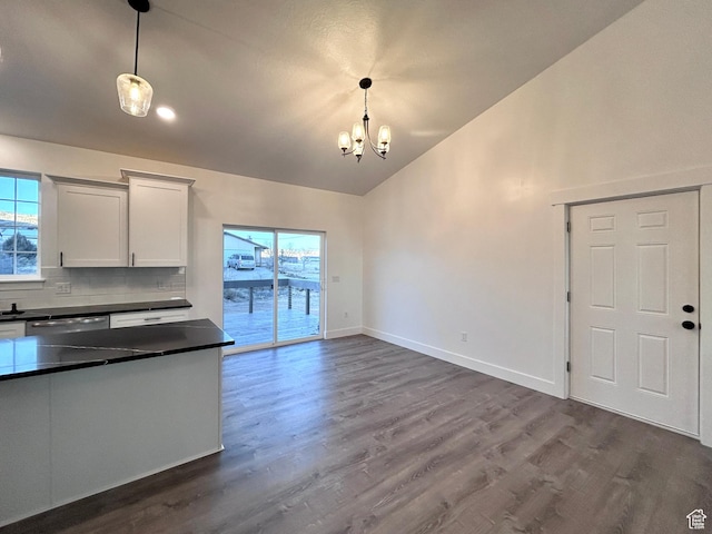 kitchen featuring decorative light fixtures, white cabinets, tasteful backsplash, and hardwood / wood-style flooring