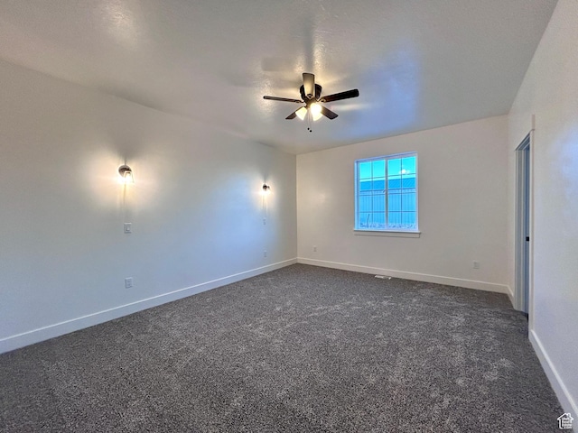 carpeted spare room with ceiling fan