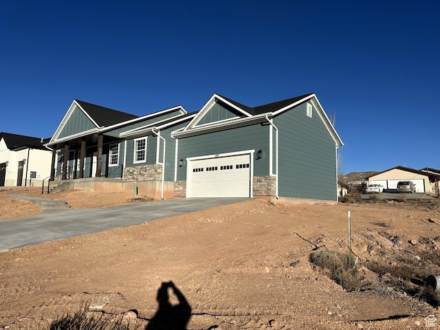 craftsman house with a porch and a garage