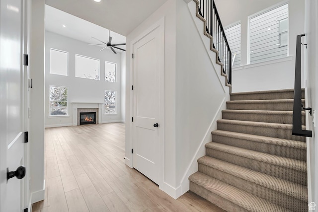 2946 N 1080 W, Lehi, UT 84043 - stairs with a glass covered fireplace, a ceiling fan, baseboards, recessed lighting, and wood finished floors