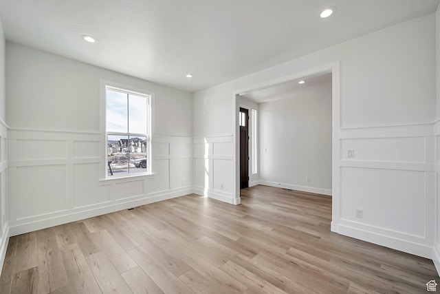 2946 N 1080 W, Lehi, UT 84043 - unfurnished room featuring light wood-style floors, wainscoting, and a decorative wall