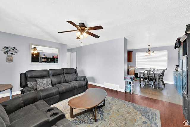 142 Green St, Layton, UT 84041 - living room featuring ceiling fan, dark wood-type flooring, and a textured ceiling