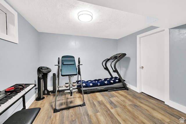 142 Green St, Layton, UT 84041 - workout area featuring light hardwood / wood-style floors and a textured ceiling